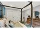 Bedroom with four-poster bed, natural light, and double door closet at 7255 Haverhill Ct, Indianapolis, IN 46250