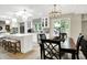 Bright kitchen and dining area with modern white cabinets, stainless steel appliances, and skylight at 7255 Haverhill Ct, Indianapolis, IN 46250