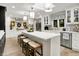 Bright kitchen features white cabinets, stainless steel appliances, and an island with seating at 7255 Haverhill Ct, Indianapolis, IN 46250