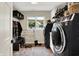 Well-organized laundry room featuring modern washer/dryer, brick floor, storage, and convenient utility sink at 7255 Haverhill Ct, Indianapolis, IN 46250