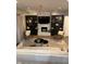 Stylish living room features a stone fireplace, custom built-ins, and elegant chandelier lighting at 7255 Haverhill Ct, Indianapolis, IN 46250
