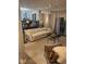 Inviting living area with modern chandelier, features a plush sofa, textured rug, and access to the outdoors at 7255 Haverhill Ct, Indianapolis, IN 46250