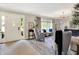 Bright and open living room with neutral tones, hardwood floors, and a large window showcasing outdoor views at 7255 Haverhill Ct, Indianapolis, IN 46250