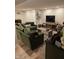 Finished basement featuring a cozy living room with a comfortable green sectional couch, and modern decor and ample space at 7255 Haverhill Ct, Indianapolis, IN 46250