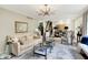 Elegant living room featuring a comfortable sofa, stylish armchairs, and contemporary lighting fixtures at 7255 Haverhill Ct, Indianapolis, IN 46250
