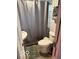 Cozy bathroom featuring a shower with curtain, toilet, and a small sink, maximizing space at 7504 N Green Meadows, Fairland, IN 46126