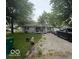 Single-story home with mature trees and a driveway with ample parking space at 7504 N Green Meadows, Fairland, IN 46126