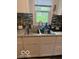 The kitchen sink area features a window with a view and granite countertops at 7504 N Green Meadows, Fairland, IN 46126