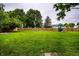 Spacious backyard features a playset and a canoe along the wood fence at 7536 Mccord St, McCordsville, IN 46055
