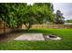Backyard area featuring a fire pit, stone patio, and view of wood fence at 7536 Mccord St, McCordsville, IN 46055