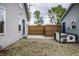 Backyard area with stone steps, wood fence, a dog house, and partial view of house at 7536 Mccord St, McCordsville, IN 46055
