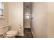 Narrow bathroom with white toilet and dark tile floor at 7536 Mccord St, McCordsville, IN 46055
