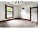Bedroom with ceiling fan, closet, and large window overlooking a tree at 7536 Mccord St, McCordsville, IN 46055