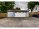 View of detached garage with asphalt driveway and blue siding at 7536 Mccord St, McCordsville, IN 46055