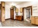 Kitchen area with an ornate dark wood door, wooden cabinets, and granite countertops at 7536 Mccord St, McCordsville, IN 46055