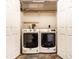 Bright laundry room with side-by-side washer and dryer and white bi-fold doors at 7536 Mccord St, McCordsville, IN 46055
