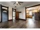 A spacious living room featuring wood flooring and contrasting wood trim, opening to the kitchen at 7536 Mccord St, McCordsville, IN 46055