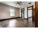 Inviting living room with a ceiling fan, wood-look flooring, and trim, bathed in natural light at 7536 Mccord St, McCordsville, IN 46055