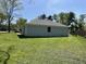 Large, grassy backyard featuring a well-maintained lawn and mature trees at 7731 Scarborough S Blvd, Indianapolis, IN 46256