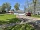 Detached two-car garage with a long driveway and a well-maintained lawn at 7731 Scarborough S Blvd, Indianapolis, IN 46256