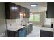 Well-lit kitchen featuring gray cabinets, white countertops, and an adjacent dining area at 7731 Scarborough S Blvd, Indianapolis, IN 46256
