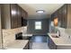Modern kitchen featuring brown cabinets, stainless steel appliances, and stylish backsplash at 7731 Scarborough S Blvd, Indianapolis, IN 46256