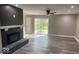 Spacious living room with a fireplace, ceiling fan, and sliding glass doors at 7731 Scarborough S Blvd, Indianapolis, IN 46256