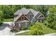Aerial view of a beautiful brick home surrounded by mature trees and lush landscaping at 7744 Preservation Dr, Indianapolis, IN 46278