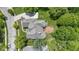 Aerial view showing the large backyard deck, mature trees, and well maintained landscaping at 7744 Preservation Dr, Indianapolis, IN 46278