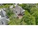 Aerial view of a backyard deck featuring a dining table surrounded by mature trees at 7744 Preservation Dr, Indianapolis, IN 46278