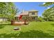 Large backyard featuring a deck, lawn, and mature trees for outdoor enjoyment at 7744 Preservation Dr, Indianapolis, IN 46278