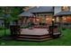 Backyard deck with tiered seating, a fire pit, and comfortable seating options at 7744 Preservation Dr, Indianapolis, IN 46278