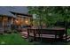 Backyard deck featuring built-in seating, wooden railings, and stairs leading to the manicured lawn at 7744 Preservation Dr, Indianapolis, IN 46278
