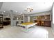 Finished basement features a billiards table, bar area, and recessed lighting for entertaining at 7744 Preservation Dr, Indianapolis, IN 46278
