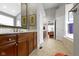 Spacious bathroom with double vanity, tiled floors, and a view to the bedroom at 7744 Preservation Dr, Indianapolis, IN 46278