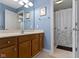 Blue bathroom featuring a spacious vanity and a floral shower curtain at 7744 Preservation Dr, Indianapolis, IN 46278