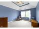 Bright bedroom with carpet floors, ceiling fan, and comfortable sitting area at 7744 Preservation Dr, Indianapolis, IN 46278