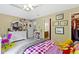 Bedroom featuring neutral carpet, ceiling fan, and an adjacent bathroom and walk-in closet at 7744 Preservation Dr, Indianapolis, IN 46278