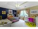 Bedroom with a ceiling fan, large window, and colorful decor at 7744 Preservation Dr, Indianapolis, IN 46278