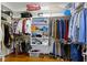 Walk-in closet with custom shelving, hanging racks, and wood flooring at 7744 Preservation Dr, Indianapolis, IN 46278