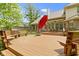Expansive wood deck with seating and a red umbrella, perfect for outdoor entertaining at 7744 Preservation Dr, Indianapolis, IN 46278