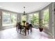Charming dining nook features tile flooring, large windows, and a chandelier at 7744 Preservation Dr, Indianapolis, IN 46278