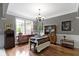 Well-lit dining room showcases hardwood floors and classic chandelier at 7744 Preservation Dr, Indianapolis, IN 46278