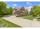 Charming two-story home featuring a brick exterior, attached garage, and well-manicured lawn at 7744 Preservation Dr, Indianapolis, IN 46278