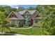 Beautiful brick home featuring a well-manicured lawn and lush landscaping at 7744 Preservation Dr, Indianapolis, IN 46278