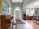 Bright foyer featuring a piano, arched doorway, and views into the dining room at 7744 Preservation Dr, Indianapolis, IN 46278