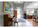Elegant foyer with a grand piano, artwork, and arched doorway at 7744 Preservation Dr, Indianapolis, IN 46278