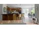 Well-lit kitchen with dark countertops, center island, barstool seating, and stainless steel appliances at 7744 Preservation Dr, Indianapolis, IN 46278