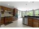 Spacious kitchen with wood cabinets, granite countertops, stainless steel appliances, and natural light at 7744 Preservation Dr, Indianapolis, IN 46278