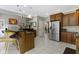 Open concept kitchen featuring stainless steel appliances and views into living room and dining nook at 7744 Preservation Dr, Indianapolis, IN 46278